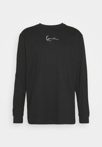 Mustaa, pitkähihainen paita, jossa pyöreä pääntie. Yläselässä valkoinen allekirjoituskuvio. Valmistettu pehmeästä puuvillakankaasta.