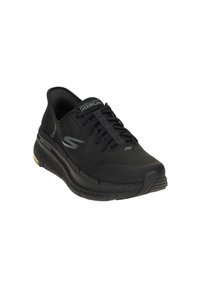 Black athletic shoe with a textured mesh upper, lace-up design, cushioned sole, and subtle branding on the tongue and side.