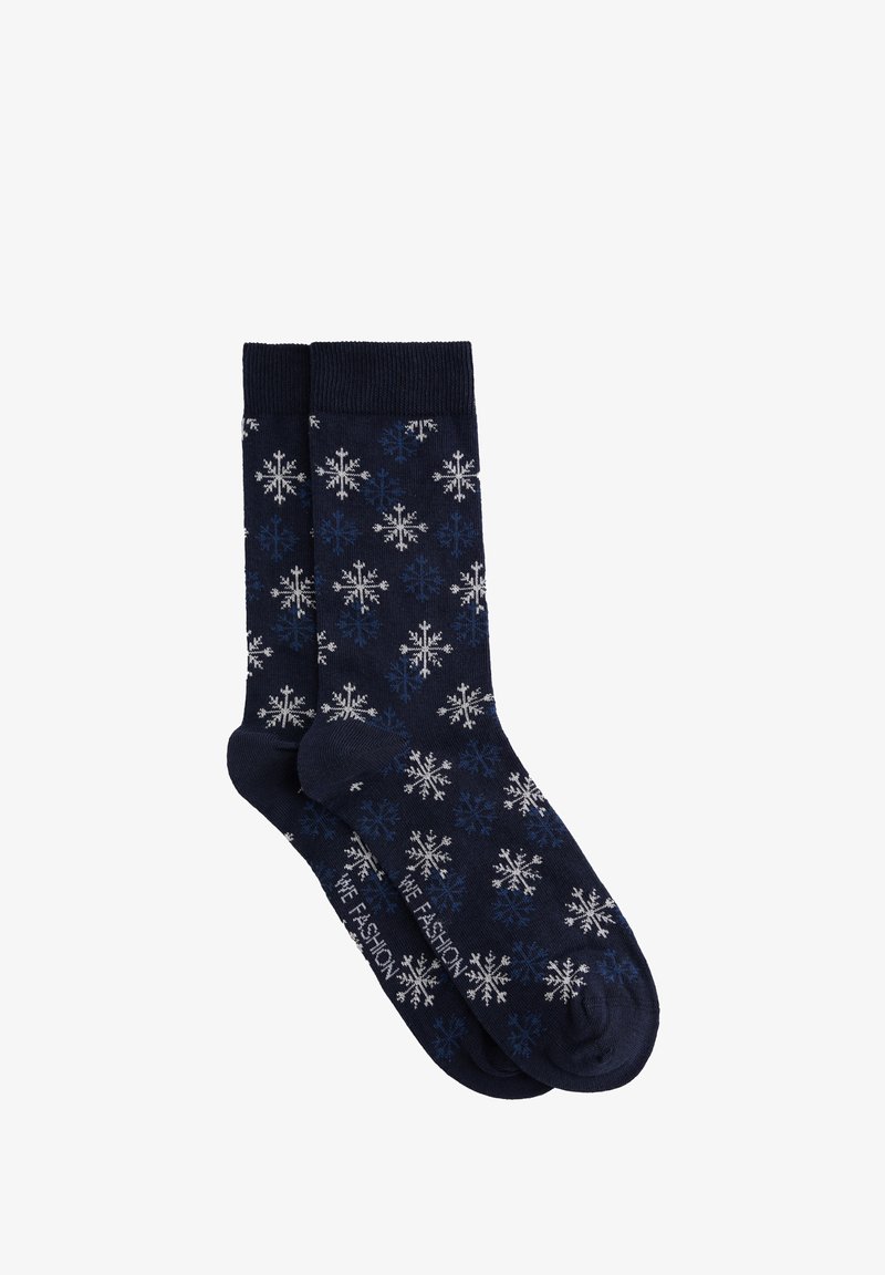 Calcetines azul marino con un patrón de copos de nieve en blanco y azul claro. Cuentan con un ribete acanalado y una textura suave de punto.