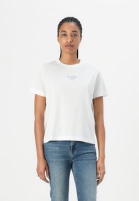 White cotton t-shirt with short sleeves, featuring blue text "ICE CREAM PLEASE" near the chest. Straight cut and simple design.