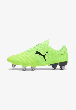 Neon green soccer cleat with a textured upper, black Puma logo, six metallic studs on the sole, and padded collar for support.
