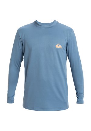 Long-sleeve blue t-shirt made of soft fabric, featuring a small orange logo on the chest and detailed printing along the sleeve.