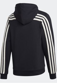 Sweat à capuche noir avec trois bandes blanches courant le long de chaque manche de l'épaule au poignet, poignets et ceinture côtelés, vu de dos.