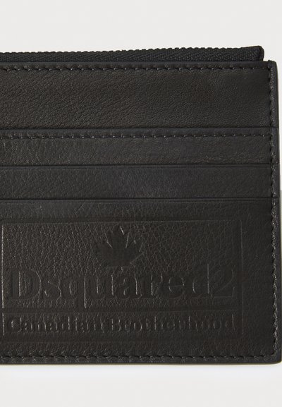 Black leather cardholder featuring multiple slots, embossed logo, and stitched edges for durability. Smooth texture with minimal detailing.