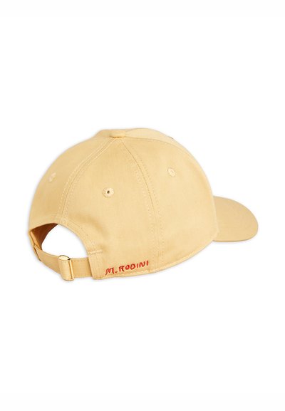 Beige cotton baseball cap with a curved brim, adjustable strap, and red embroidered "M. RODINI" logo at the back. Textured fabric.