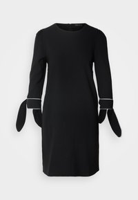 Black dress with long sleeves, featuring puff detailing and tie accents at the cuffs. Simple design and smooth texture. Back zip closure.