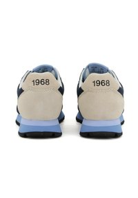 Sneaker blu marinoc e beige con tacco in suede, dotate della scritta "1968" in rilievo sul retro e una suola intermedia azzurro chiaro per l'ammortizzazione.