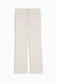 Pantalons de jogging couleur crème en tissu doux, dotés d'une taille élastique avec cordons de serrage et de deux poches latérales zippées pour le rangement.