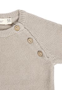 Beige knitted baby sweater with three wooden buttons on shoulder and ribbed collar, labeled size 56.