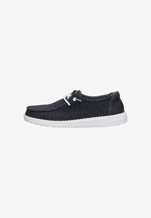 Scarpa slip-on casual blu scuro con lacci bianchi e suola imbottita bianca, vista laterale su sfondo bianco.