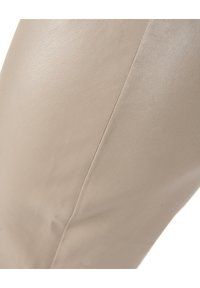 Beige læder ankelstøvle med en glat tekstur, prydet med et sidesøm. Designet er strømlinet og formtilpasset.