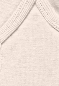 White cotton fabric with a fine ribbed texture. Features a cross-over neckline with soft, stretchy binding. Smooth and even surface overall.