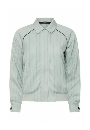 Giacca grigio chiaro con zip, sottili righe verticali, piping nero sulle spalle, polsini con bottoni e orlo a coste.