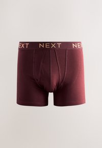 Boxer da uomo color marrone scuro con fascia elastica marchiata con la scritta "NEXT" in lettere dorate.