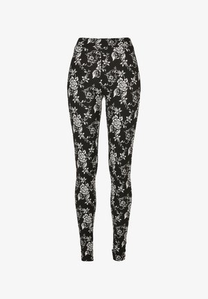 Zwarte leggings met een wit bloemenpatroon, met een elastisch en aansluitend ontwerp. De stof lijkt glad met een zachte textuur.