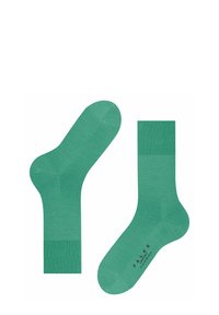 Grüne Socken aus weichem, strukturiertem Material mit einem gerippten Bund. Verfügt über eine glatte Innensohle und ein bedrucktes Logo auf der Sohle.