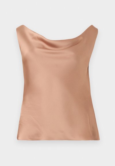 Satin camisole in light peach, featuring a relaxed fit with a scoop neckline and smooth texture, ideal for layering or standalone wear.