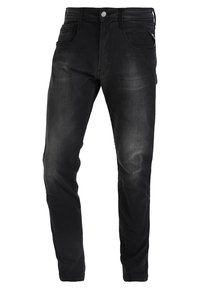 Jeans de denim negro con corte slim, que presentan un diseño de cinco bolsillos, cierre delantero con cremallera y un ligero acabado desgastado. Detalles en metal con botón y cremallera.