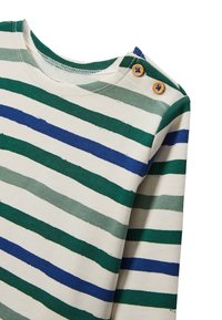 Chemise à manches longues rayée en crème, avec de larges bandes vertes et bleues. Deux boutons en bois à l'épaule et un col rond.