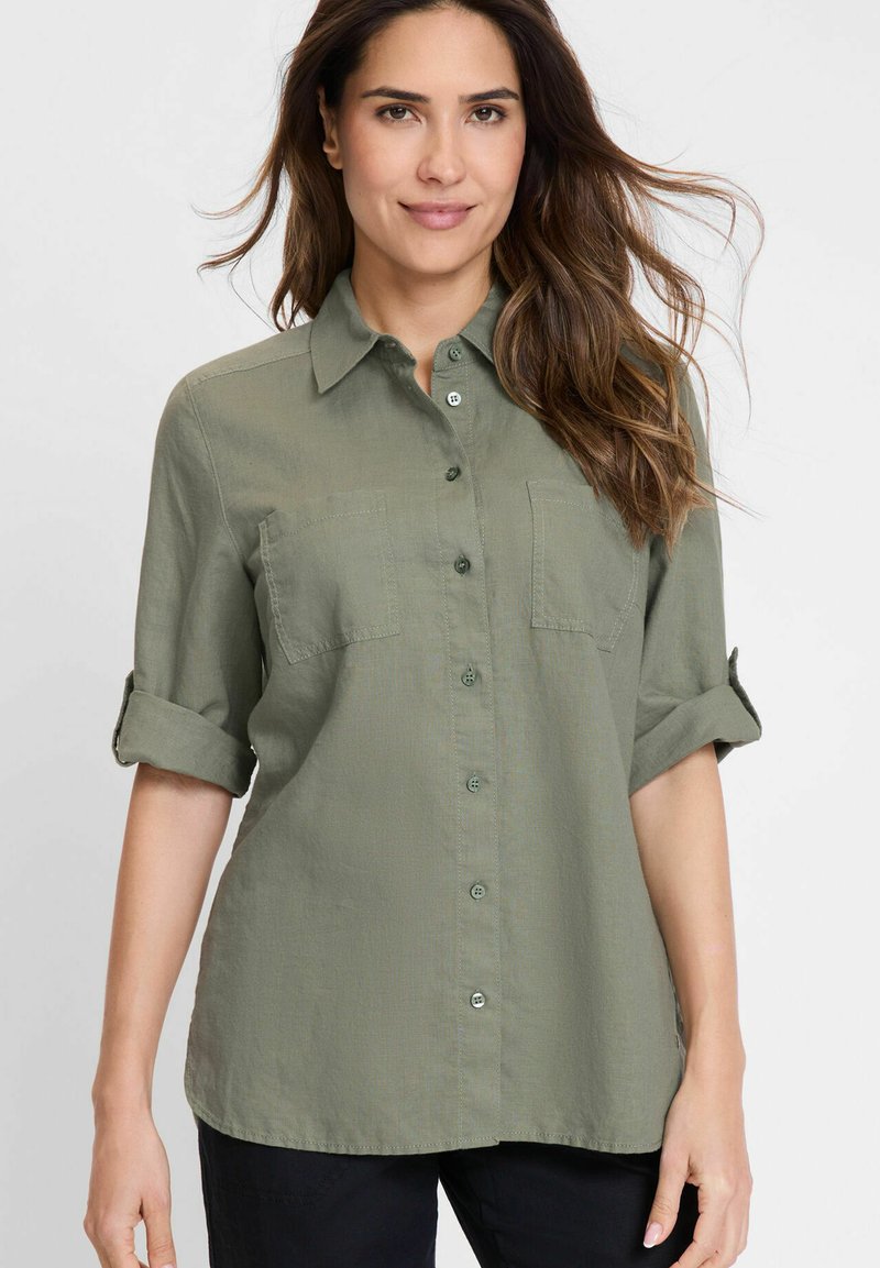 Olive green button-up shirt made of lightweight fabric. Features roll-up sleeves and two chest pockets. Classic collar and simple button closure.