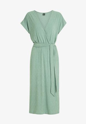 Zielona sukienka w stylu kopertowym z głębokim dekoltem w kształcie litery V, krótkimi rękawami i regulowanym paskiem. Teksturowany materiał ma delikatny prążkowany wzór.