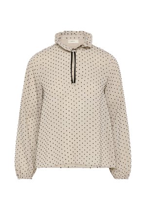 Beige bluse med lange ærmer, sort prikmønster, høj flæset krave og sort bindebånd foran, elastiske manchetter på ærmerne.