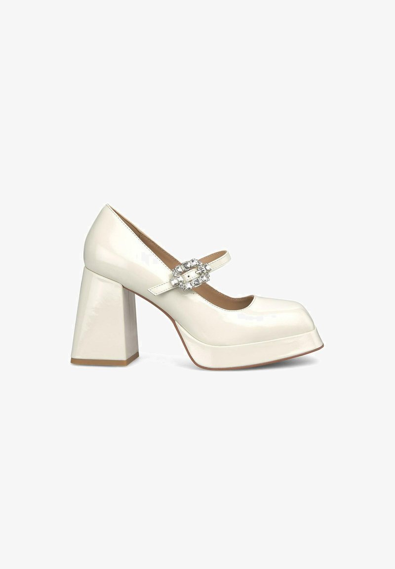 White patent leather chunky heel shoe with a round toe, Mary Jane strap, and a decorative clear gem buckle on the side.