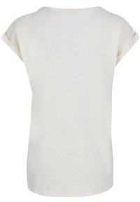 Short-sleeve t-shirt in solid off-white. Soft cotton material with a round neckline and rolled cuffs. Straight fit with a smooth texture.