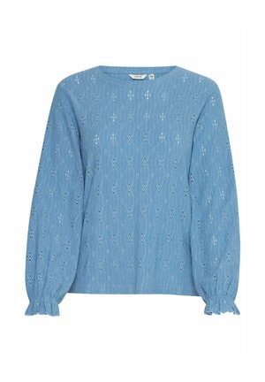 Šviesiai mėlynas medvilninis blužonas su ilgomis pūstomis rankovėmis, apvaliu iškirpimu ir siuvinėtomis aklėmis visame paviršiuje. Sukrauti rankogaliai ant rankovių.