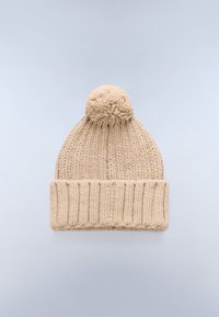 Beige knitted hat with a ribbed cuff and a fluffy pom-pom on top. Made from thick yarn, featuring a soft and textured appearance.