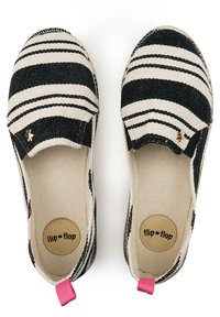 Canvas slip-on shoes with black and white stripes, pink heel tabs, and lightweight design. Features a round, cushioned insole labeled "flip*flop."