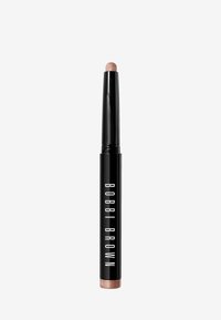 Bobbi Brown oogschaduwstick met een zwarte houder. Kenmerkt een afgeronde, lichtroze punt en een metallic bronzen basis. Soepele textuurontwerp.