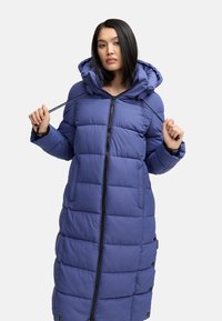 Long, padded purple coat with a hood, featuring a front zipper and two side pockets. The fabric has a smooth texture and stitched pattern.