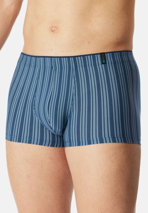 Male torso and upper thighs wearing blue boxer briefs with vertical white stripes on a plain white background.