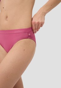 Rosa Stretchstoffslip mit glatter Textur, breitem Bund an der Taille, Logo-Detail und minimalistischem Design. Passend an den Hüften.