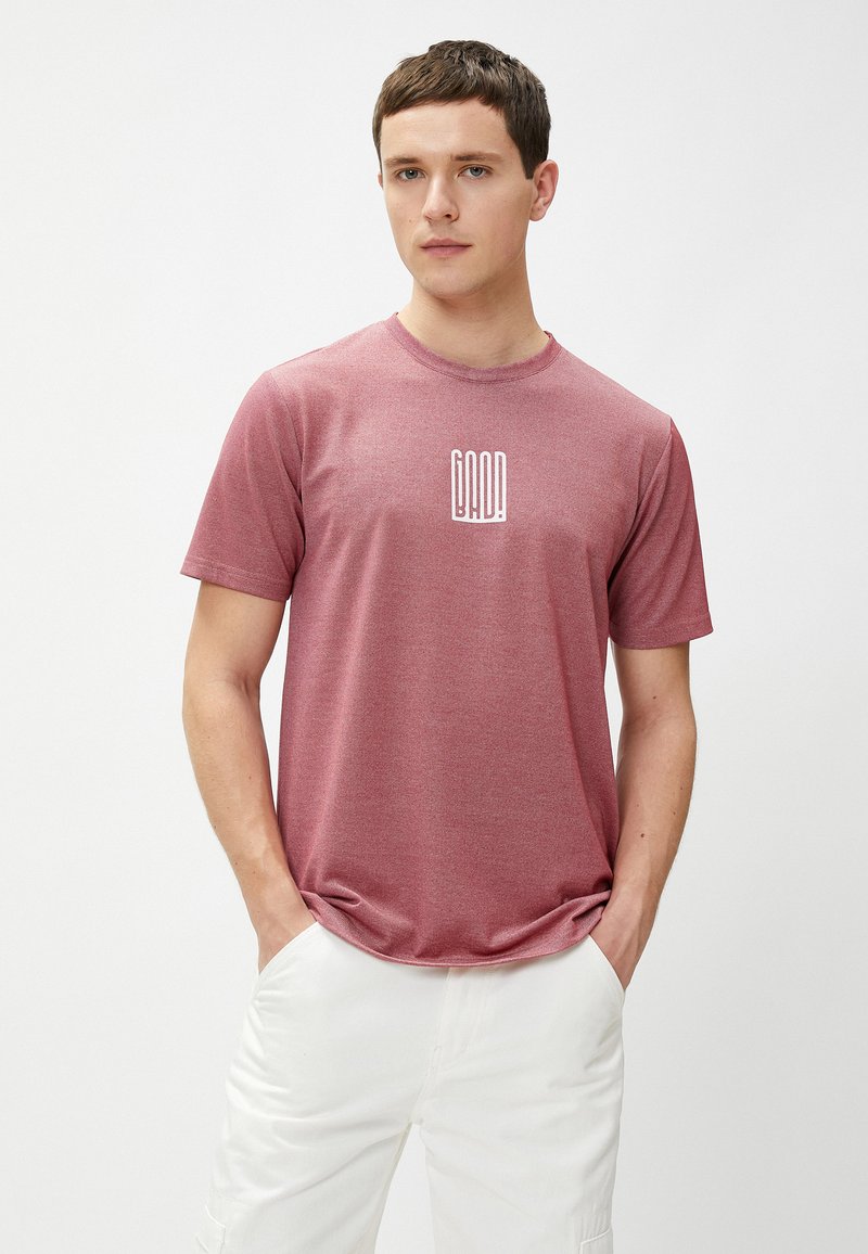 Czerwony melanżowy t-shirt z okrągłym dekoltem, wykonany z lekkiego materiału, z białym nadrukiem "DAD!" na piersi. Krótkie rękawy, luźny krój.