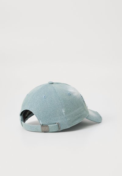Light blue denim cap with a curved brim, adjustable strap, and distressed details on the fabric. Features ventilation eyelets.