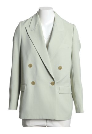 Veste croisée vert clair avec larges revers et quatre boutons marron, exposée sur un buste de mannequin blanc.