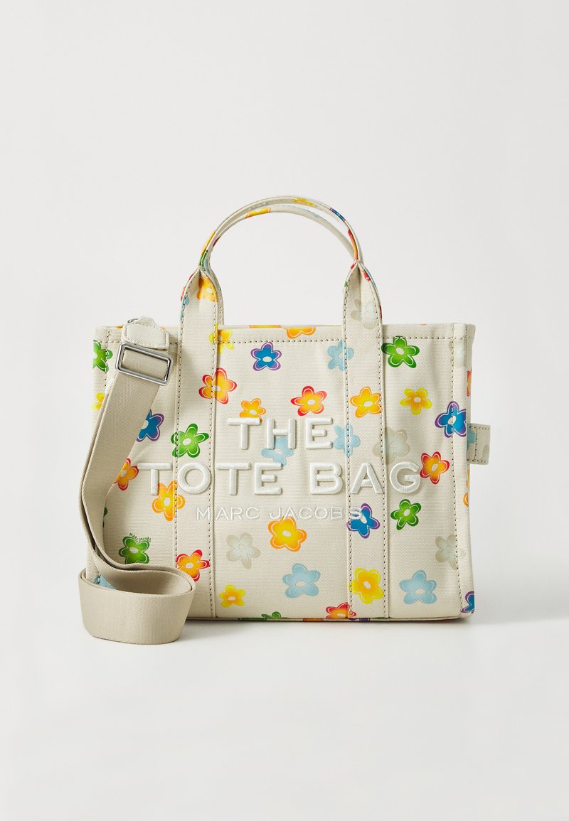 Small tote bag in light beige fabric with colorful floral prints. Features dual top handles and a detachable, adjustable shoulder strap.
