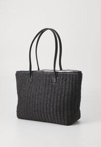 Black woven tote bag with smooth black leather handles, rectangular shape, and textured body; features a solid color with no patterns.