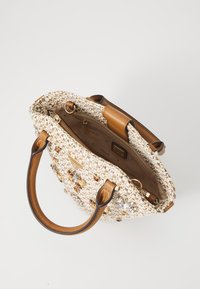 Woven handbag in beige and white, featuring brown leather handles, gold hardware, and decorative gems on the front. Opened view shows interior.