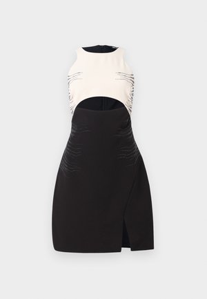 Black and cream dress with a sleeveless design, featuring cutouts, metallic accents, and wave patterns embossed on the material.
