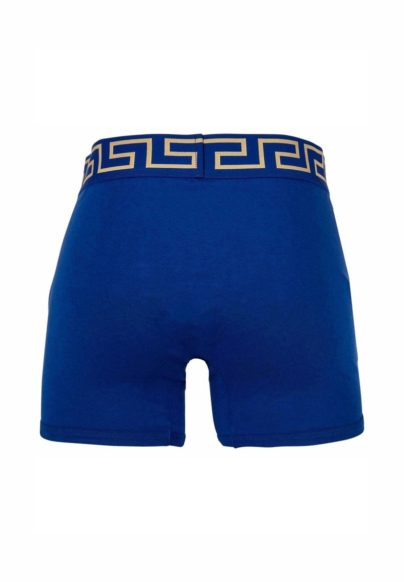 Blue cotton boxer shorts with a gold Greek key patterned waistband. Features a snug fit and a smooth texture.