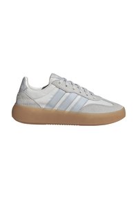 Zapatillas de deporte gris claro con acabados de cuero suave y gamuza, que presentan tres rayas horizontales azules en el lateral y una suela de goma.