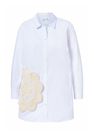 Biała koszula z długim rękawem i zapięciem na guziki, z dużym beżowym akcentem z koronkowego szydełka po lewej stronie, który nadaje fakturę i szczegółowy design.
