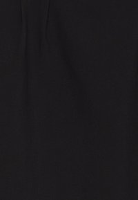 Tissu noir avec une texture lisse, présentant des plis subtils. Aucun motif ou accent distinct n'est visible. Design uni classique.