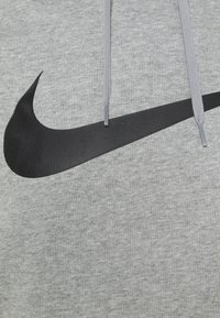Gray hoodie with a black Nike swoosh logo. Features gray drawstrings and a textured fabric. Simple, sporty design.