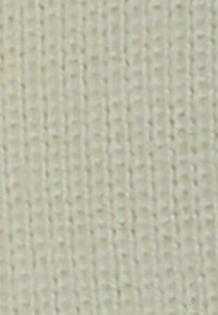 Tissu tissé de couleur crème clair présentant un motif texturé en forme de grille avec des lignes verticales et horizontales régulièrement espacées.