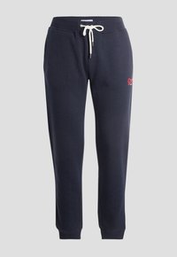 Pantalones jogger azul marino hechos de tela suave, cuentan con una cinturilla elástica con cordón y puños acanalados. Incluyen un pequeño detalle de logo.
