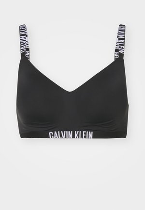 Schwarzer Bralette mit glatter Textur, V-Ausschnitt-Design und elastischen Trägern mit dem weißen "Calvin Klein"-Logo am Bund.